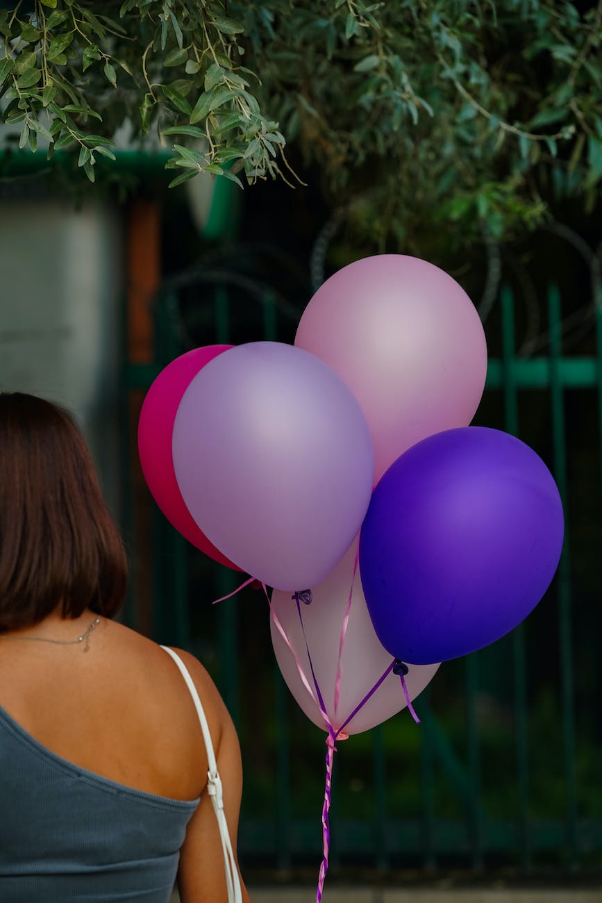 woman standing next to balloons